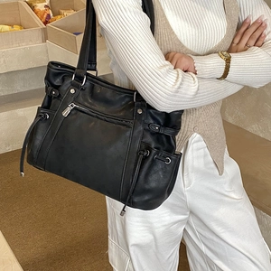 Minimalist black large capacity tote bag with drawstring side pockets and wide straps