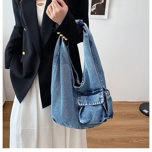 Classic washed blue denim tote bag with functional flap pocket and wide strap details