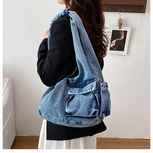 Close-up of retro denim tote bag with cargo pocket shown in a lifestyle street style