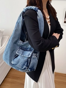 Vintage washed denim shoulder bag with wide strap and buckle pocket detail