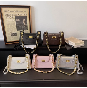 Detail of five colors of vintage trapezoid handbags with gold chain and turn-lock closure