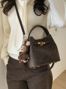 Brown frosted leather trapezoid handbag with gold clasp and cute bear charm pendant