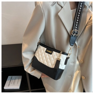 Detail of checkered square bag with wide jacquard strap and gold metal brand logo