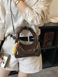Dark brown pleated dumpling bag with silver chain strap and colorful bead charm