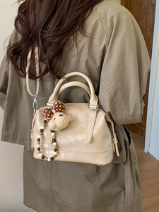 Beige vintage large capacity tote bag with bear charm shown on a female model