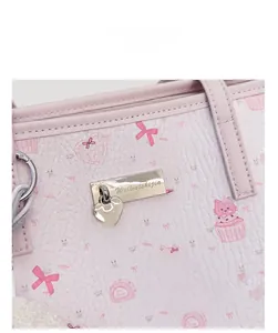 Detail of pink faux leather tote bag with cartoon cat print and heart-shaped pendant