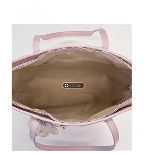 Pink tote bag interior detail showing the spacious main pocket and zippered inner pouch