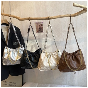 Close-up of quilted hobo bags in multiple colors featuring star charms and chain straps