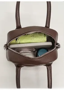 Internal view of brown textured leather baguette bag showing phone and umbrella storage