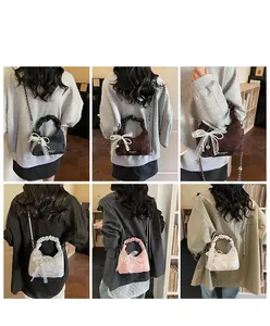 Model display of pleated crescent bags with lace bows and metal chain straps in various colors