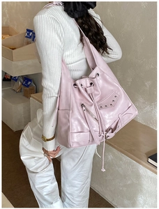 Close-up of pink punk tote bag with silver studs and long zipper tassels details