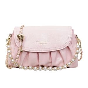 Pink beaded crossbody bag with golden chain and white pearl decoration on white background
