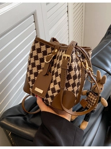 Vintage houndstooth bucket bag with brown leather trim and cute rabbit charm