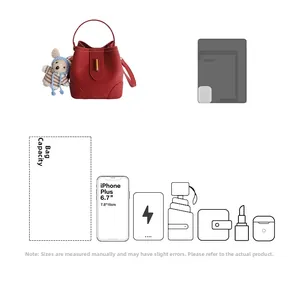 Internal capacity of the red bucket bag showing space for phone and essentials