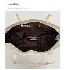 Detailed interior of large white tote bag with brown lining and secure zipper pocket