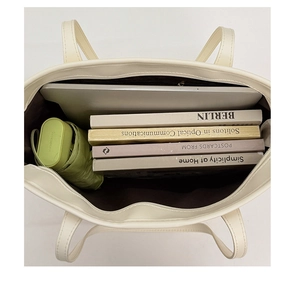 Top view of large cream tote bag interior showing capacity for laptop and books