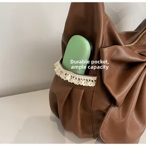 Detail of durable brown PU shoulder bag side pocket with lace trim and large capacity