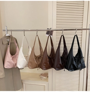 Detailed row of tote bags in six colors featuring stylish front bow drawstring accents