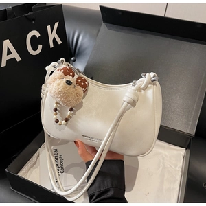 White hobo shoulder bag in gift box with a brown teddy bear charm and logo detail