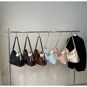 Multiple colors of large vintage crescent tote bags with cute bear charm accessories