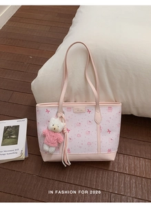 Detail of pink tote bag with bear print, plush charm and Luomeinisha leather label