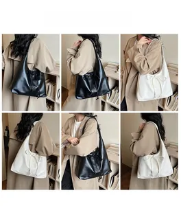 Detailed views of leather tote bag with bow drawstring details worn by model