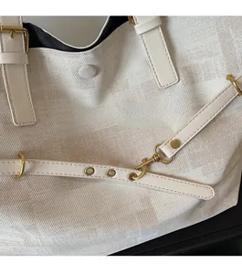 Detail of premium golden hardware and twill fabric texture on a vintage tote bag