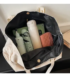 Top view showing large capacity tote bag with water bottle, umbrella, and daily essentials