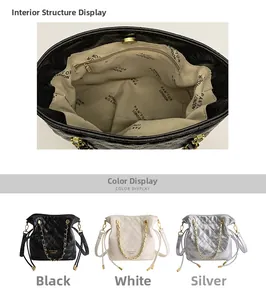 Detail of quilted bucket bag interior and silver chain straps in black white and silver