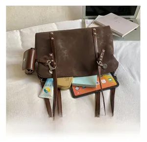 Brown vintage suede hobo bag showing spacious interior with tablet and daily essentials