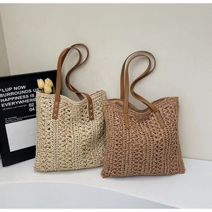 Close-up of woven hollow tote bags with brown leather handles in beige and tan colors