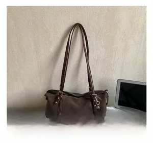 Detail view of a vintage dark brown shoulder bag with a matching mini zipper pouch