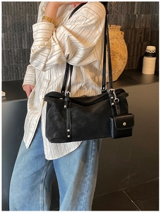 Detail of black suede tote bag with detachable small coin purse and silver metal hardware
