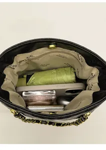 Top view of spacious interior of vintage chain bag with phone, umbrella, and inner pocket