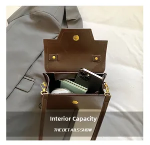 Detail showing internal capacity of the brown vintage crossbody bag with gold hardware