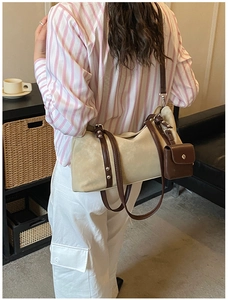 Detail view of large cream suede tote bag with brown leather straps and small coin pouch