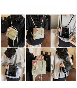 Detail view of retro patent leather backpack with cute plush charm and adjustable straps