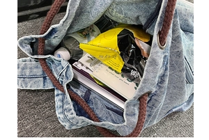 Interior view of blue washed canvas backpack showing large capacity and drawstring closure