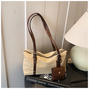 Detail of beige suede shoulder bag with brown leather straps and matching mini pouch