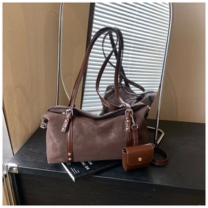 Close-up of matte coffee shoulder bag with suede texture and mini coin purse detail