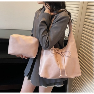 Detailed view of pink tote bag set with drawstring bow accent and matching inner pouch
