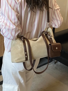 Retro two-tone shoulder bag in beige suede and brown leather shown with a casual model outfit