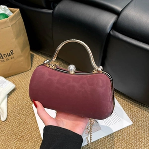 Elegant burgundy suede chain evening bag with gold handle and pearl clasp detail