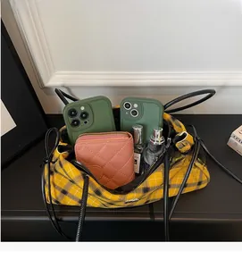 Detailed top view showing the spacious interior of the plaid tote bag with essentials