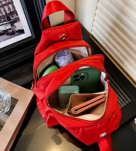Detail view of red oxford backpack showing internal storage for umbrella and phone