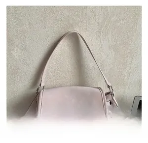 Detail of soft pink matte backpack featuring a flap closure and adjustable drawstring