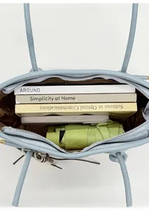 Vue de dessus montrant l'intérieur spacieux et la doublure brune du grand sac bleu