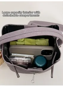 Spacious interior of purple leather tote bag showing items like umbrella and phone