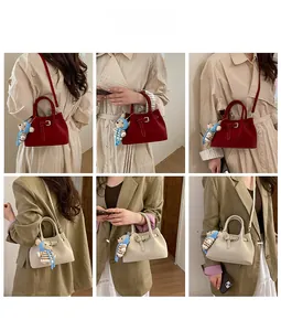 Detail showing red and beige pleated bucket bags with cute bear charm and shoulder strap