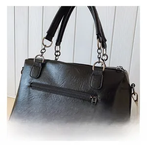 Detail view of the retro black PU leather tote showing the side zipper and chain handle